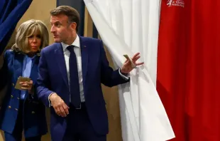 O presidente francês Emmanuel Marcon e sua mulher, Brigitte Macron, saem de cabine de votação depois de votarem nas eleições europeias do último domingo (9).