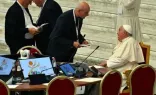 Papa Francisco fala com participante do Sínodo em reunião do Sínodo da Sinodalidade na Aula Paulo VI, no Vaticano, em 10 de outubro de 2024.