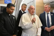 Papa Francisco fala a jornalistas a bordo do avião papal com destino à Mongólia, com o futuro cardeal George Jacob Koovakad à esquerda, em 31 de agosto de 2023.