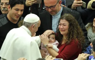 Papa abençoa um bebê durante a Audiência.